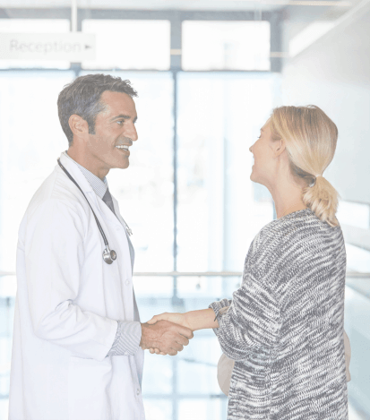 Woman shaking hands with dentist