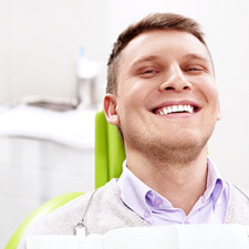 Smiling man sitting in dental office