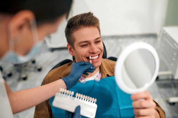Patient in Tuckahoe smiling in mirror at dentist