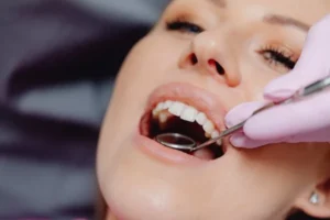 Dentist examining woman’s mouth