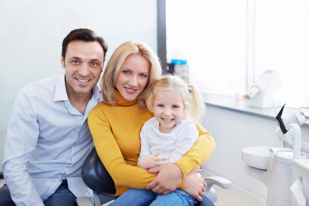 happy mom and dad with baby family dentistry in Short Pump